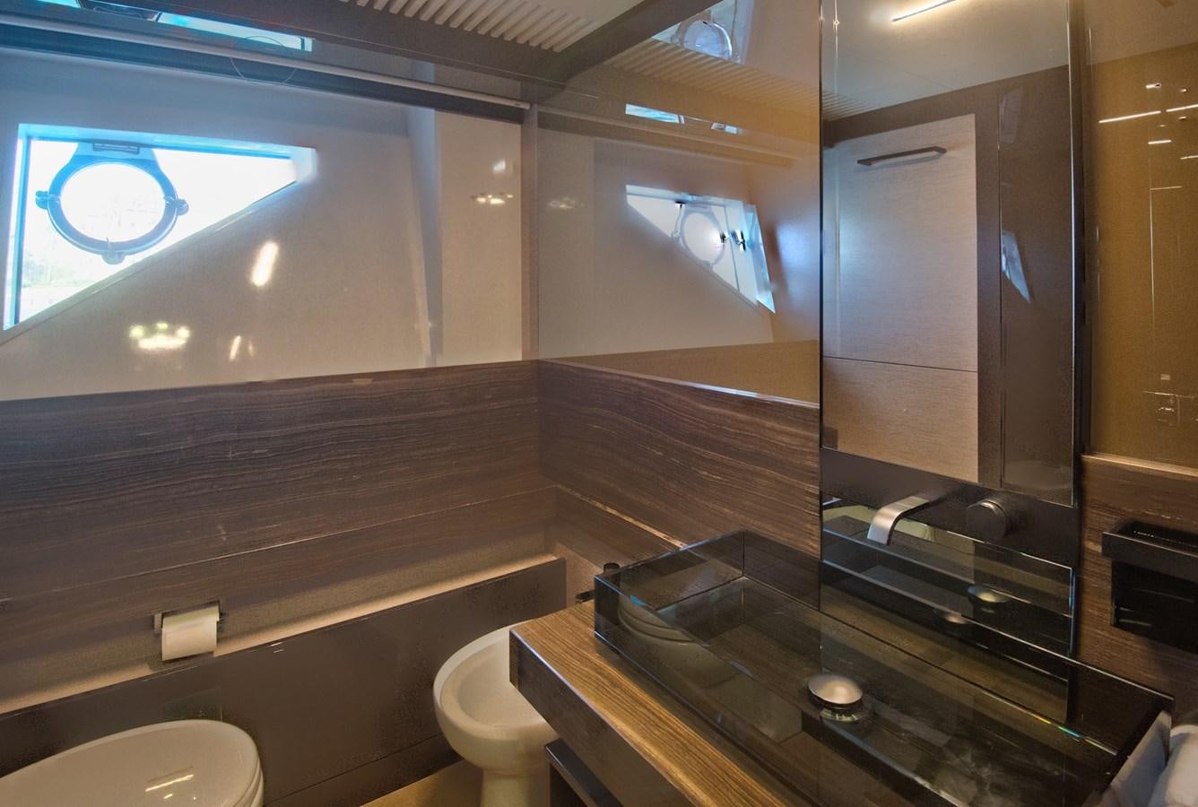a bathroom with a glass shower aboard CIAO II Yacht for Sale