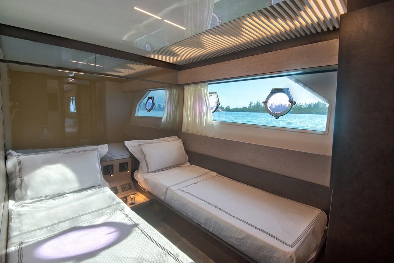 a room with two beds aboard CIAO II Yacht for Sale
