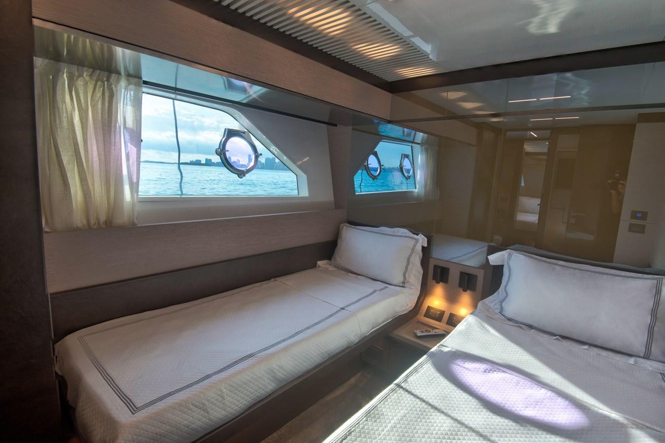a room with a bed and a tv on the wall aboard CIAO II Yacht for Sale