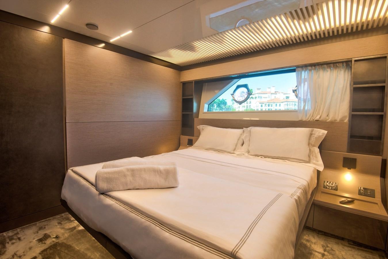 a bed with a white bed spread aboard CIAO II Yacht for Sale