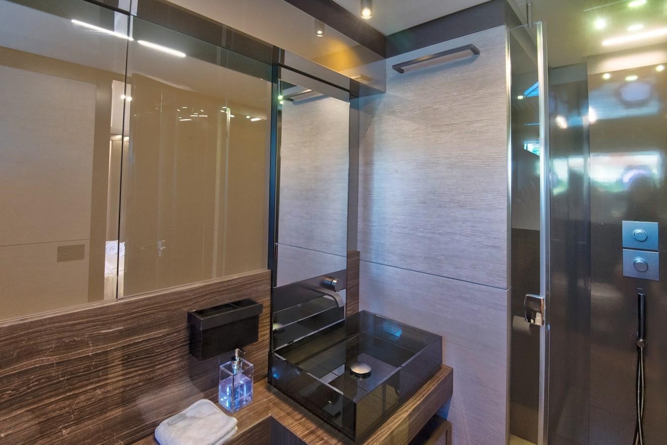 a bathroom with a countertop sink and a large mirror aboard CIAO II Yacht for Sale