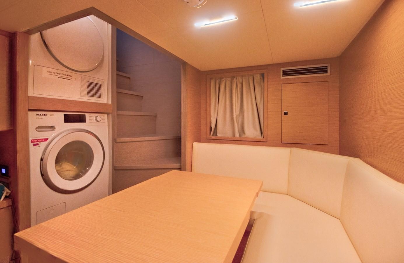 a room with a bed and a washing machine aboard CIAO II Yacht for Sale