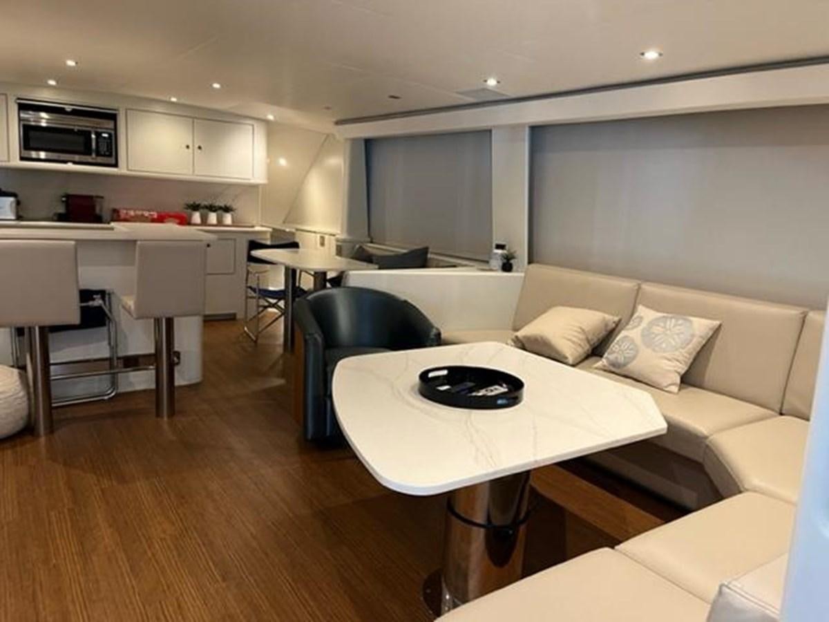a living room with a table and chairs aboard CENTURY STAR Yacht for Sale