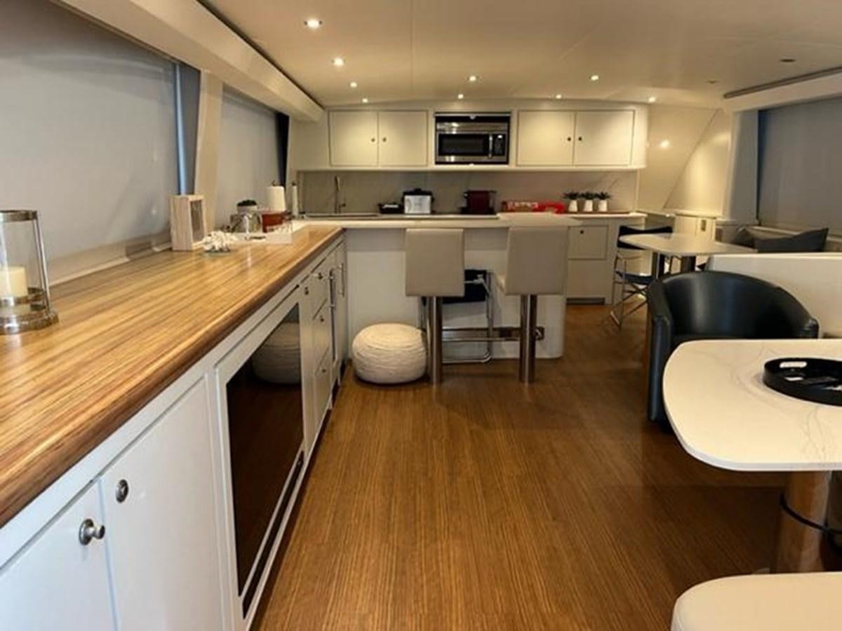 a kitchen with a wood floor aboard CENTURY STAR Yacht for Sale