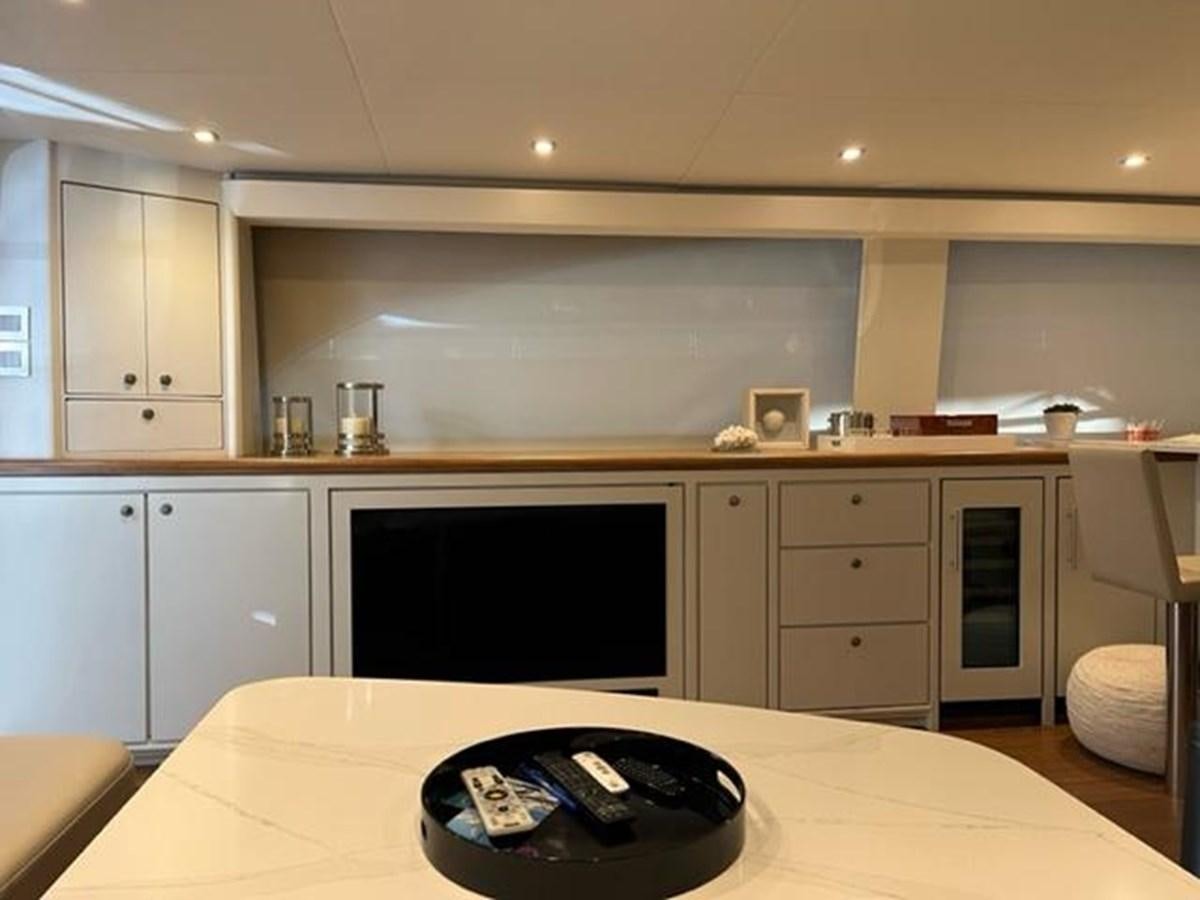 a kitchen with a television and a laptop on a table aboard CENTURY STAR Yacht for Sale