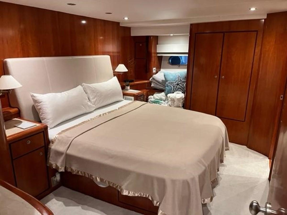a room with a bed and a wood wall aboard CENTURY STAR Yacht for Sale
