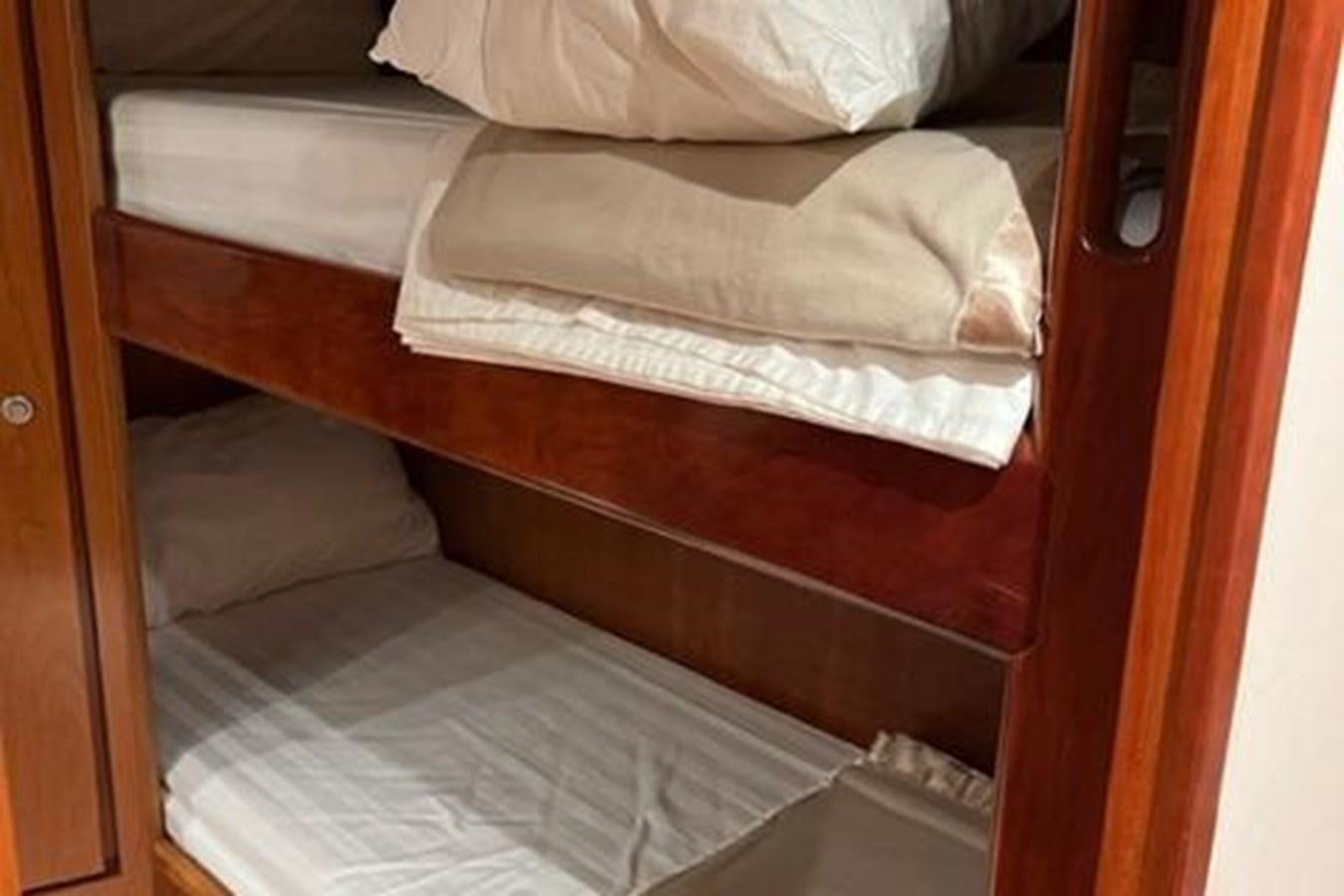 a bed with white sheets aboard CENTURY STAR Yacht for Sale