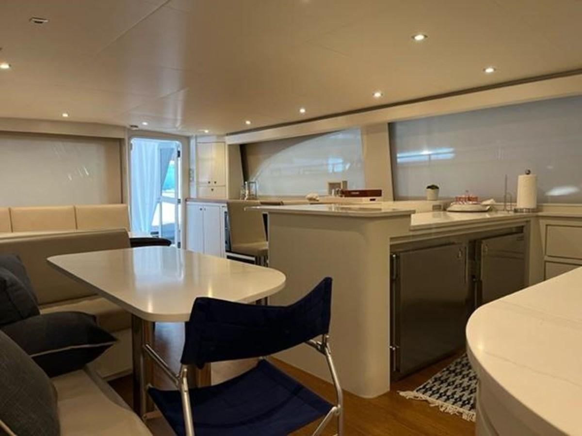 a kitchen with a table and chairs aboard CENTURY STAR Yacht for Sale