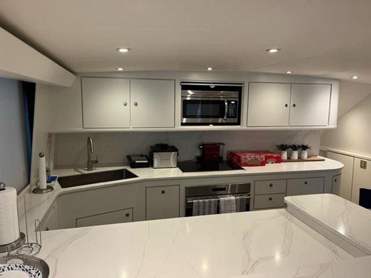a kitchen with white cabinets aboard CENTURY STAR Yacht for Sale