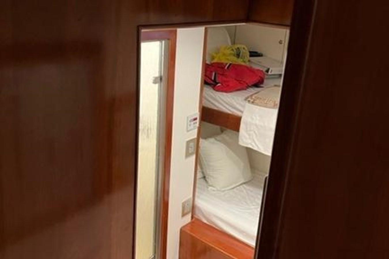a closet with a bed and a window aboard CENTURY STAR Yacht for Sale