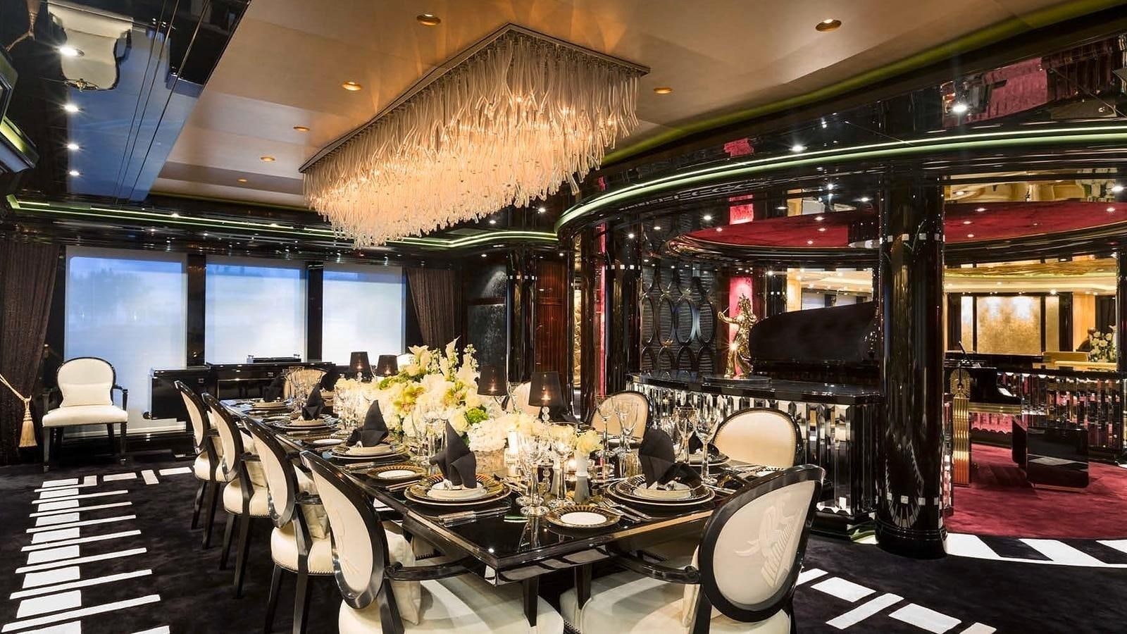 a room with tables and chairs aboard PHOENIX 2 Yacht for Sale