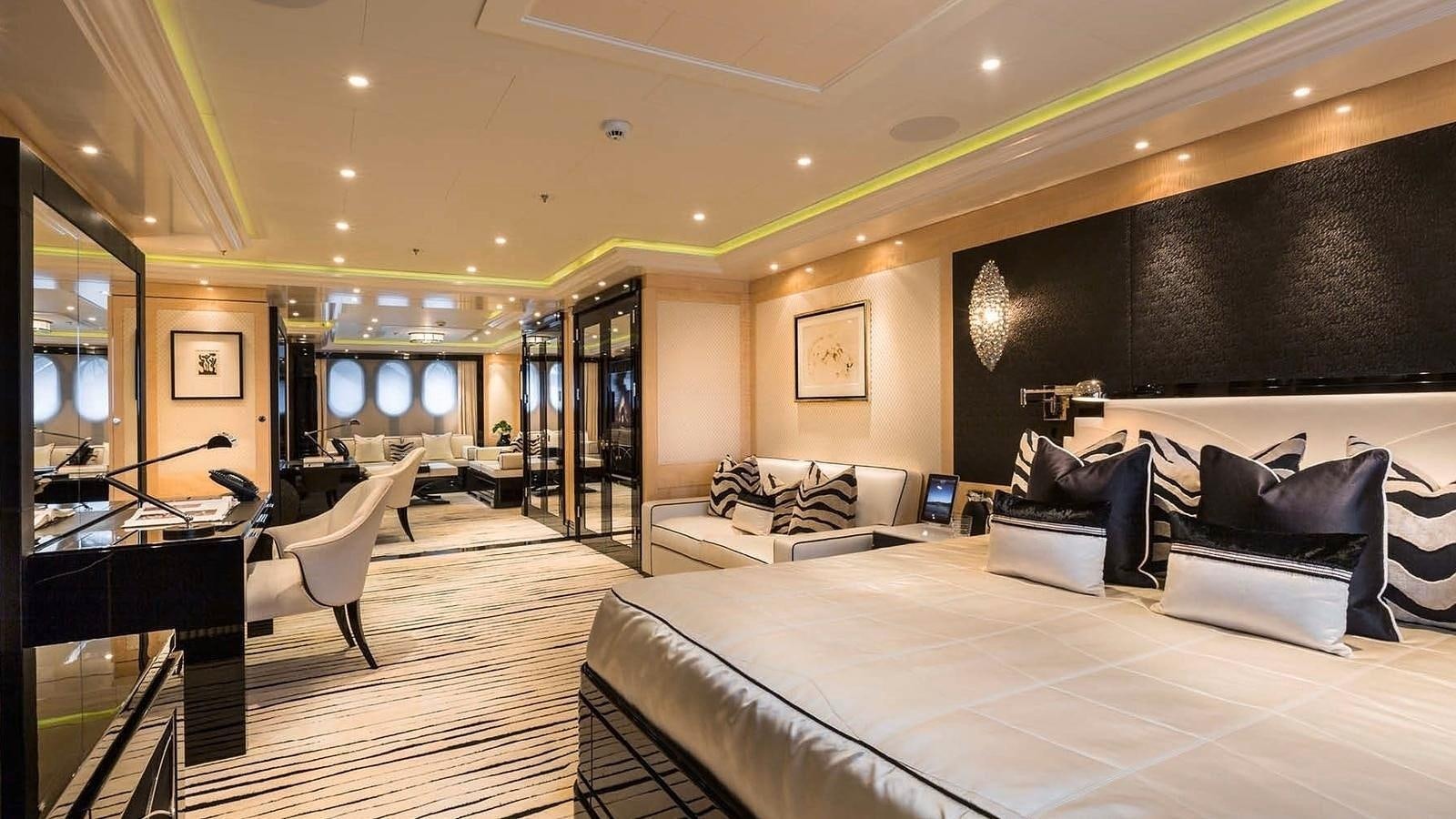 a room with a couch and a tv on the wall aboard PHOENIX 2 Yacht for Sale