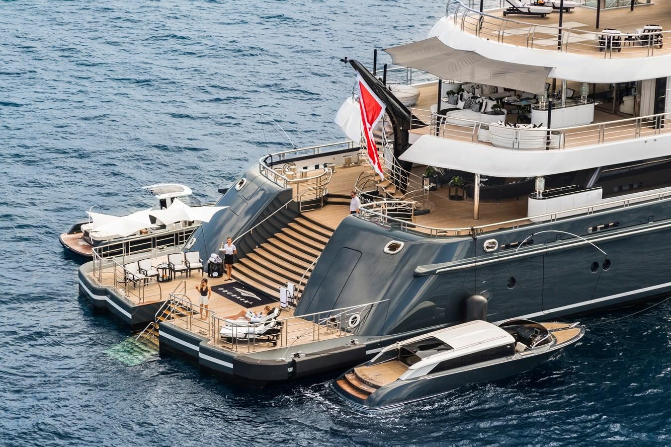a large boat with a flag on it aboard PHOENIX 2 Yacht for Sale