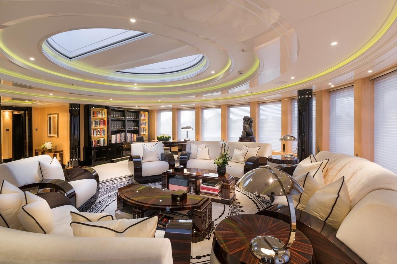 a living room with a large chandelier aboard PHOENIX 2 Yacht for Sale