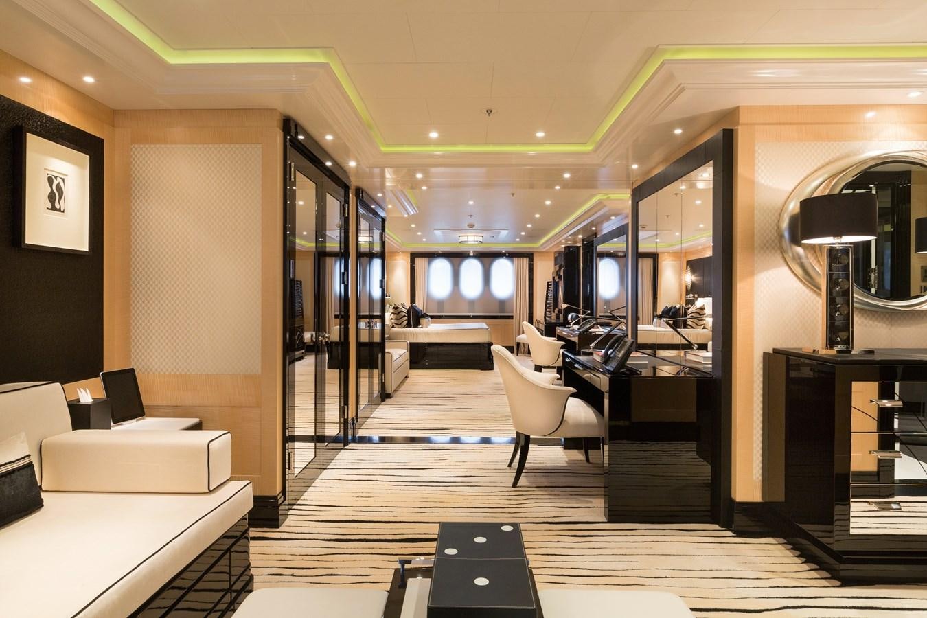 a room with a large mirror and desks aboard PHOENIX 2 Yacht for Sale