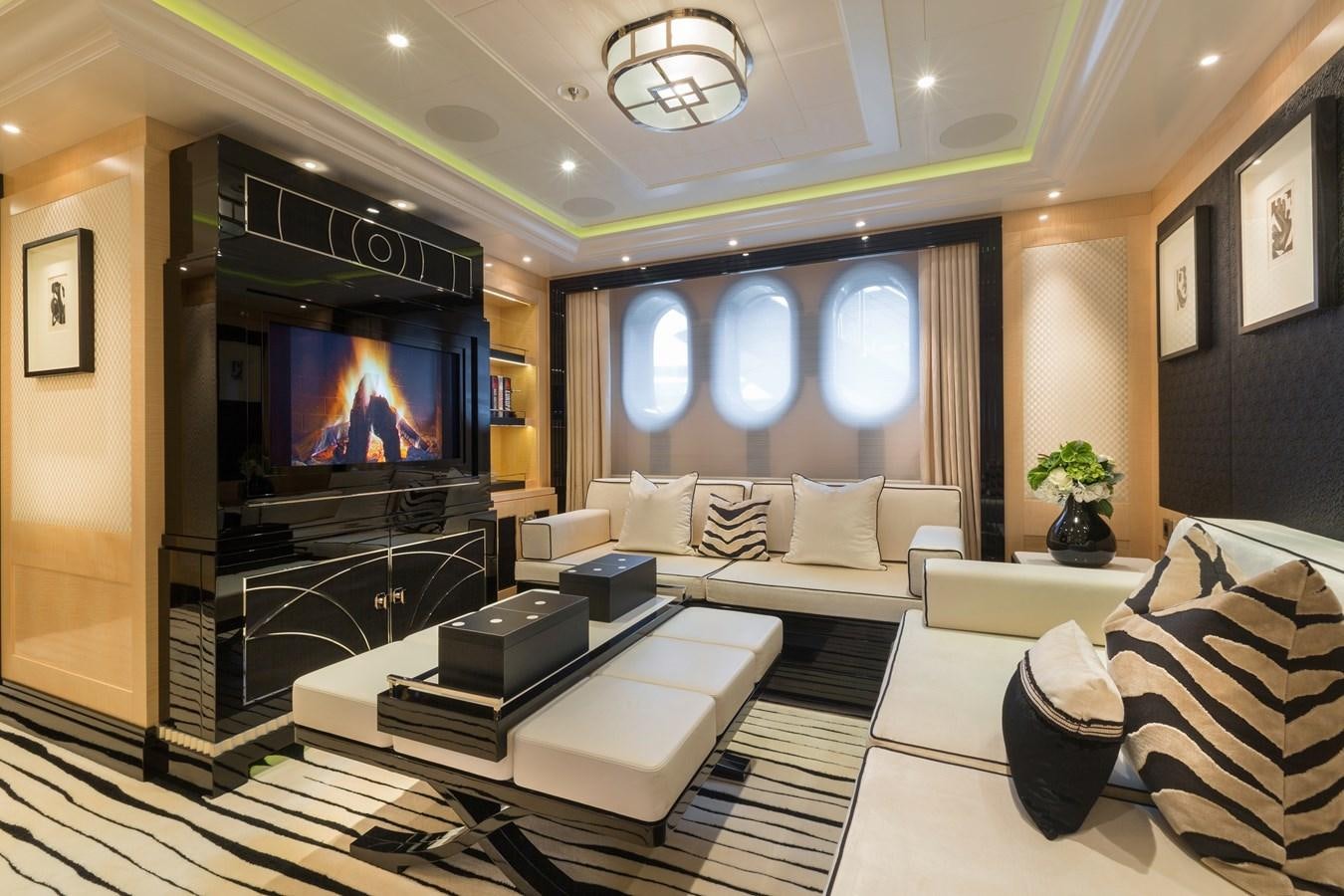 a living room with a large tv aboard PHOENIX 2 Yacht for Sale