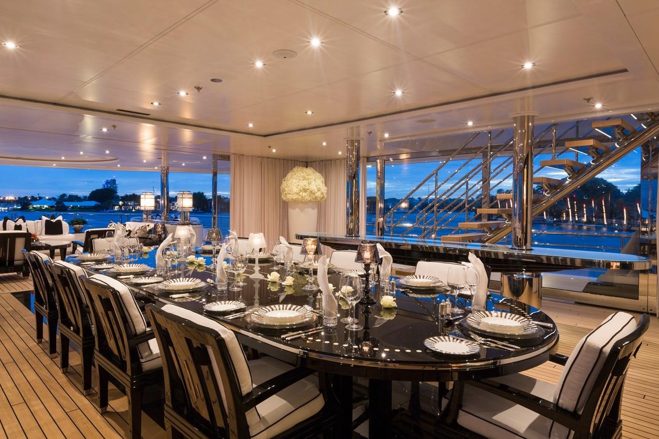 a large room with tables and chairs aboard PHOENIX 2 Yacht for Sale