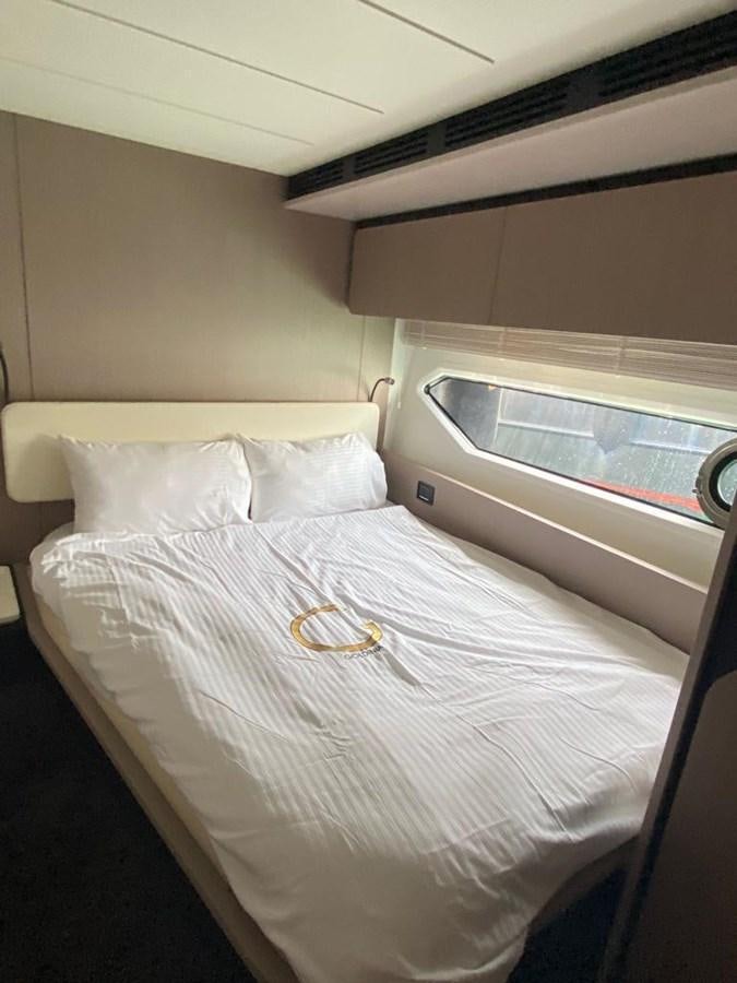 a bed with a white sheet and a white pillow aboard GOLDINIA Yacht for Sale