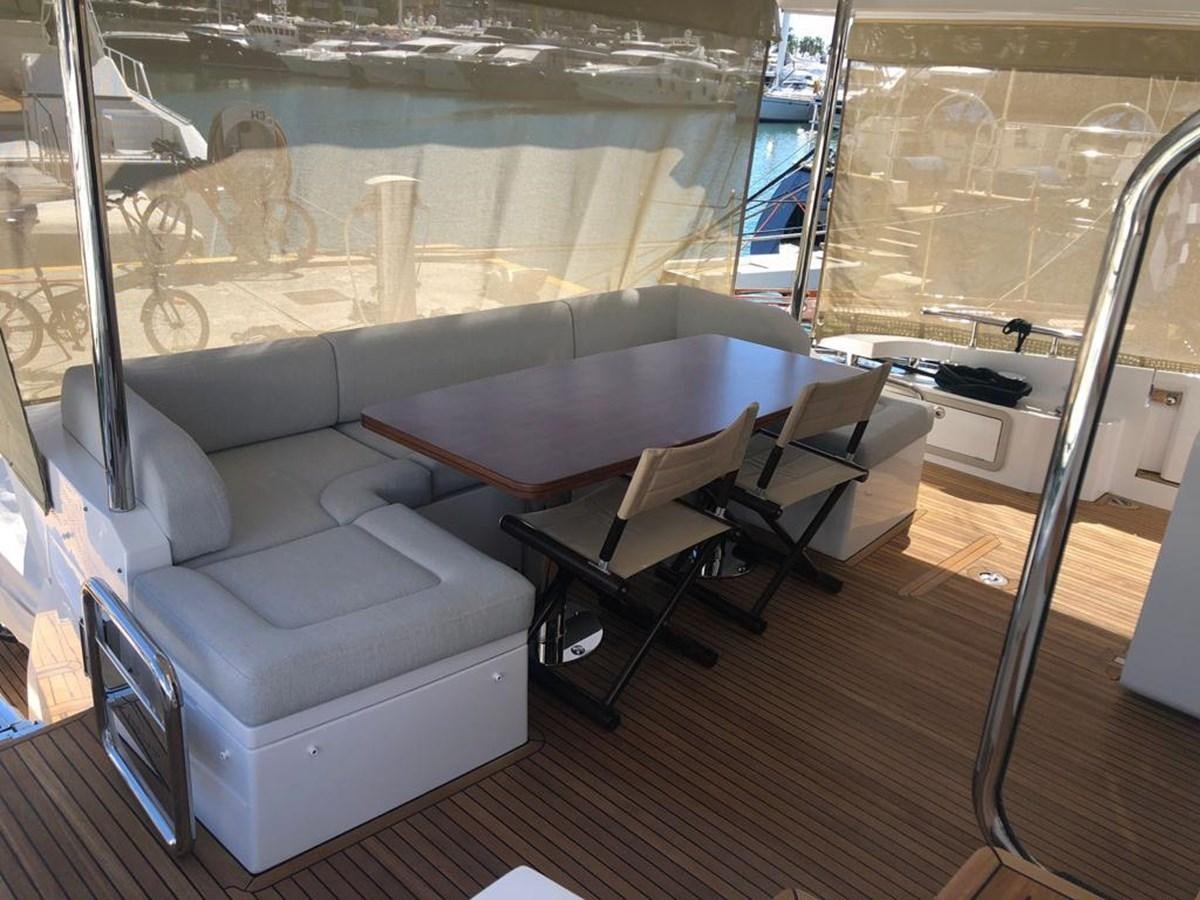 a room with a couch and a table and chairs aboard GOLDINIA Yacht for Sale