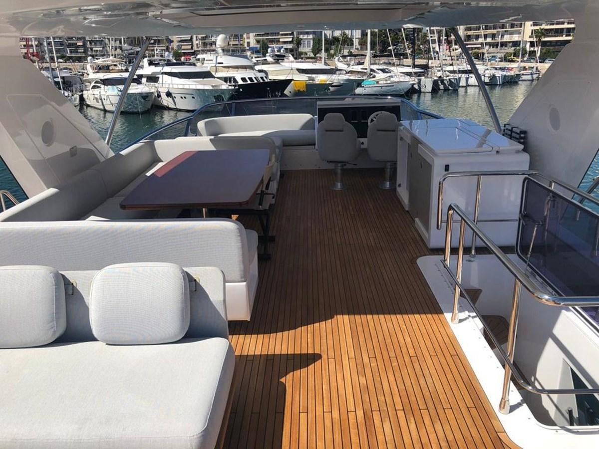 a boat deck with chairs and a table on it aboard GOLDINIA Yacht for Sale