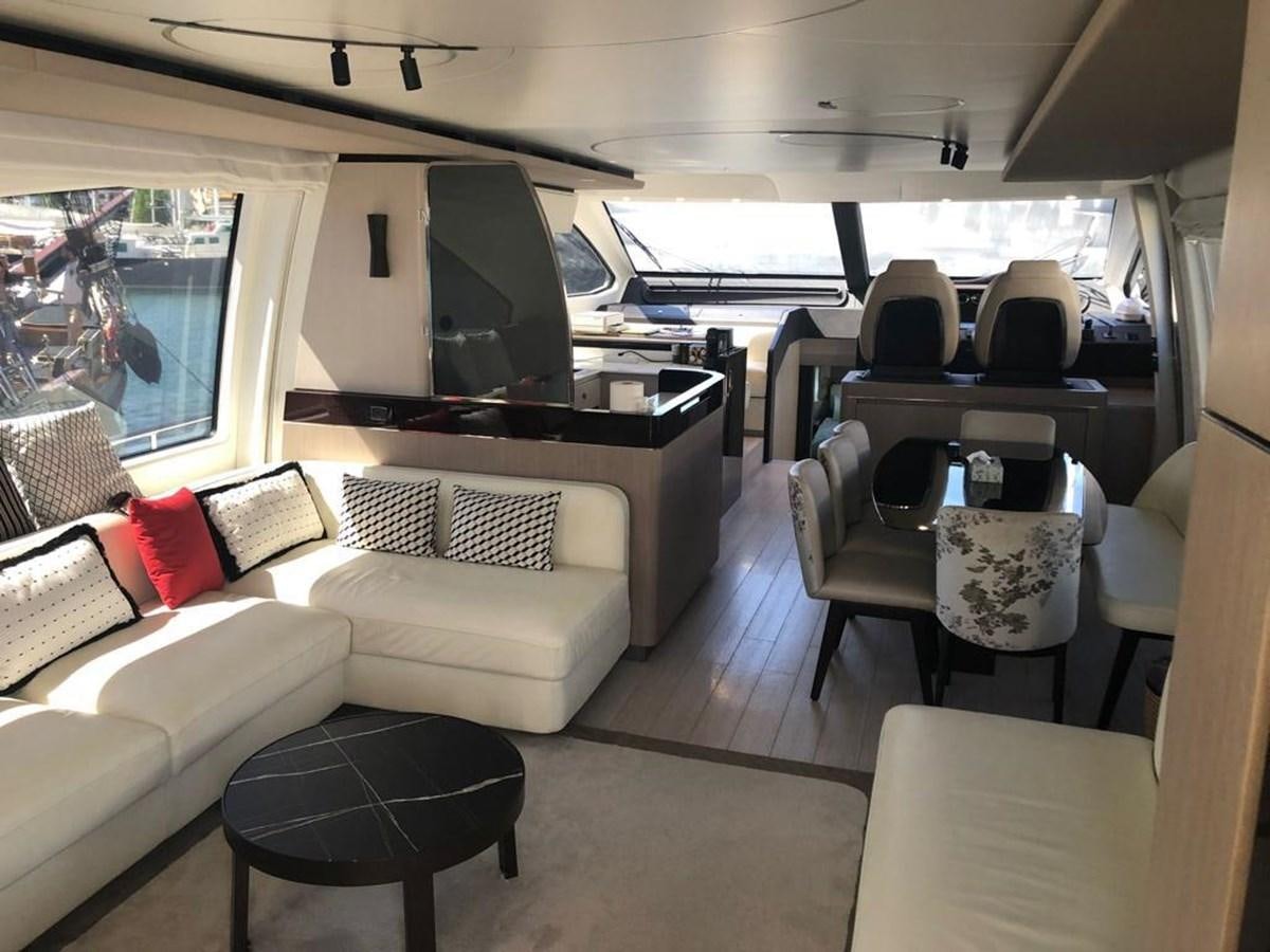 a room with a couch and a table aboard GOLDINIA Yacht for Sale