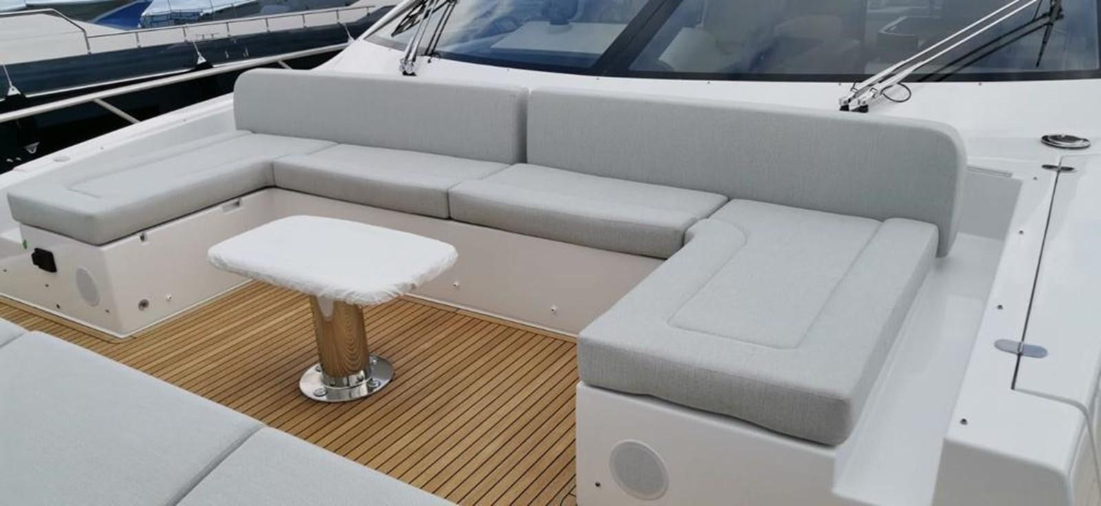 a white couch with a glass table aboard GOLDINIA Yacht for Sale