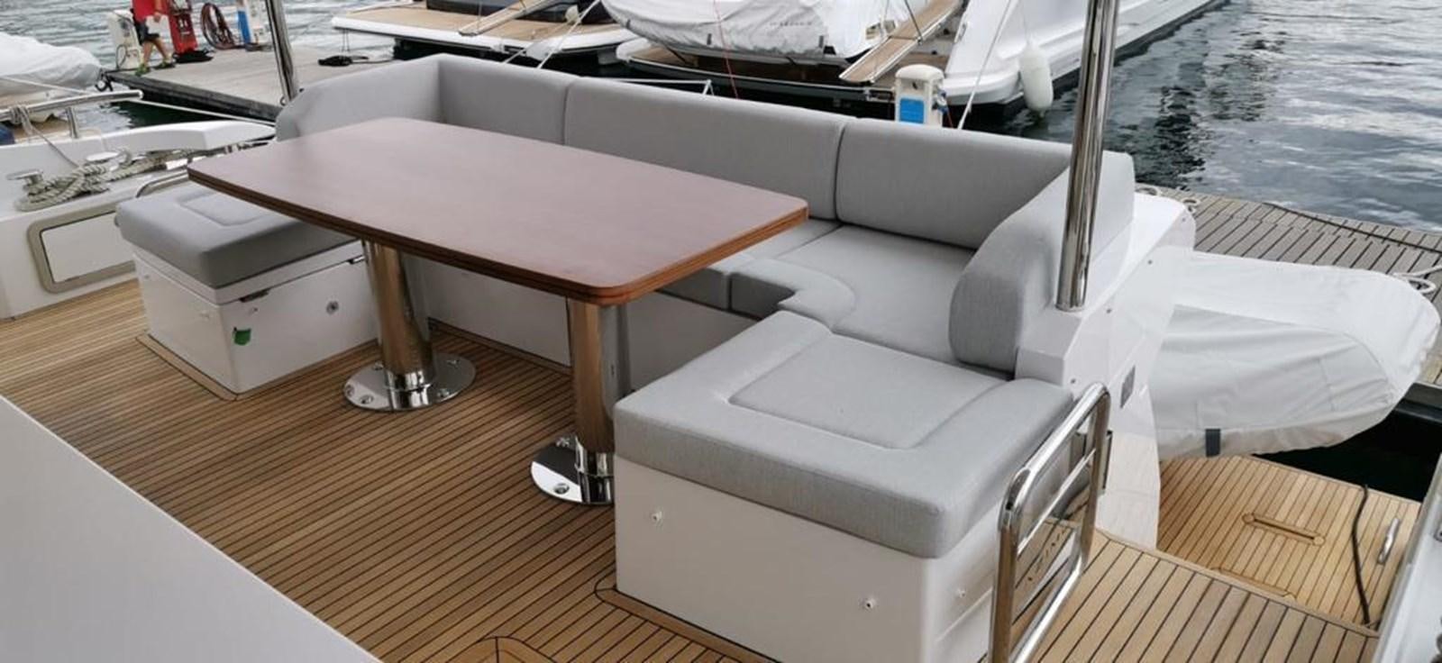 a white couch in a room aboard GOLDINIA Yacht for Sale