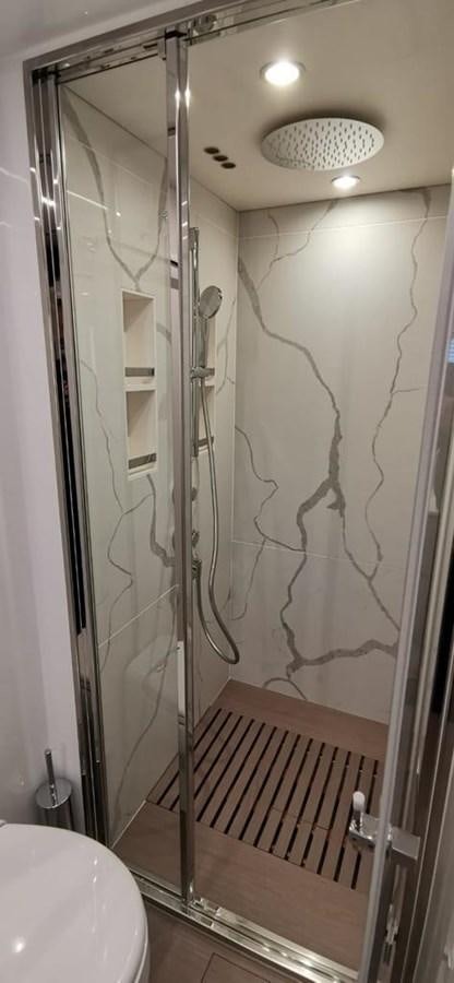 a bathroom with a shower aboard GOLDINIA Yacht for Sale