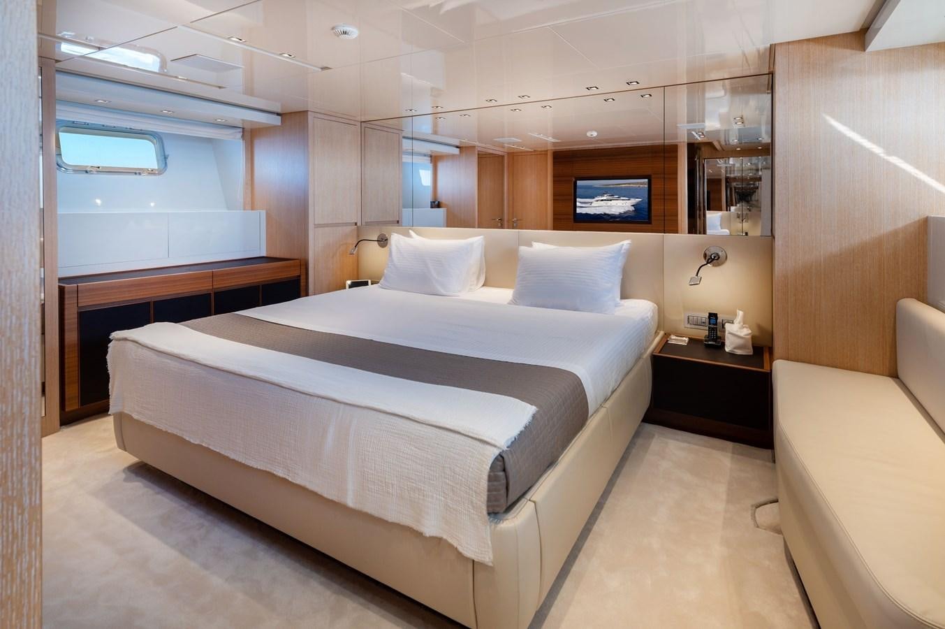 a room with a bed and a desk aboard VITTORIA I Yacht for Sale
