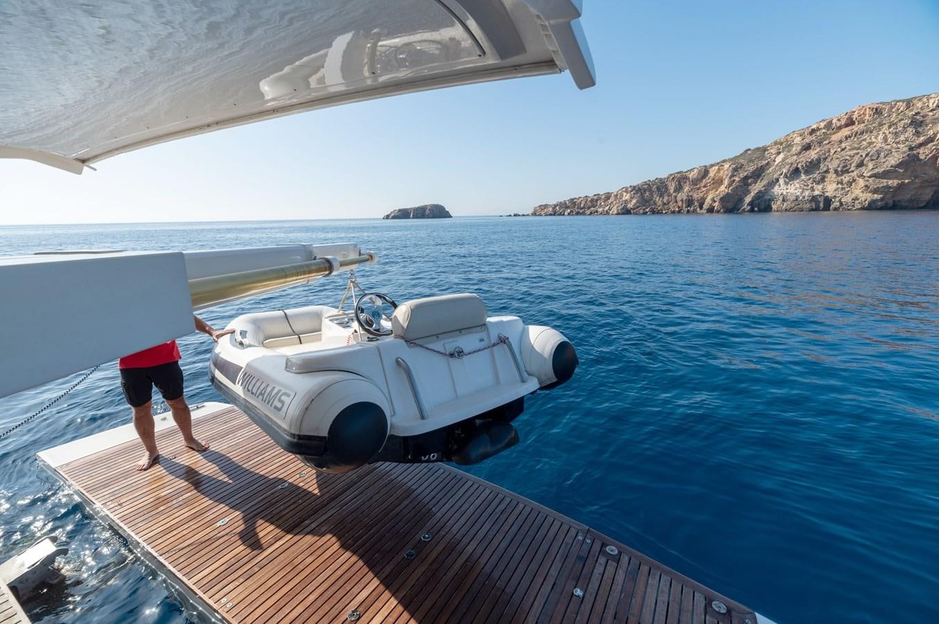 a person standing on a dock next to a boat aboard VITTORIA I Yacht for Sale