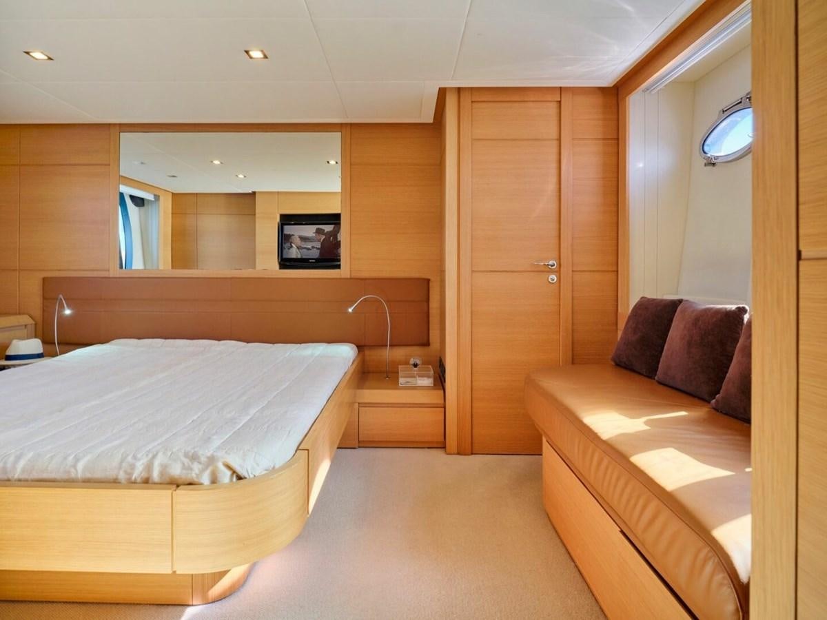 a room with a bed and a mirror aboard SPLENDID V Yacht for Sale