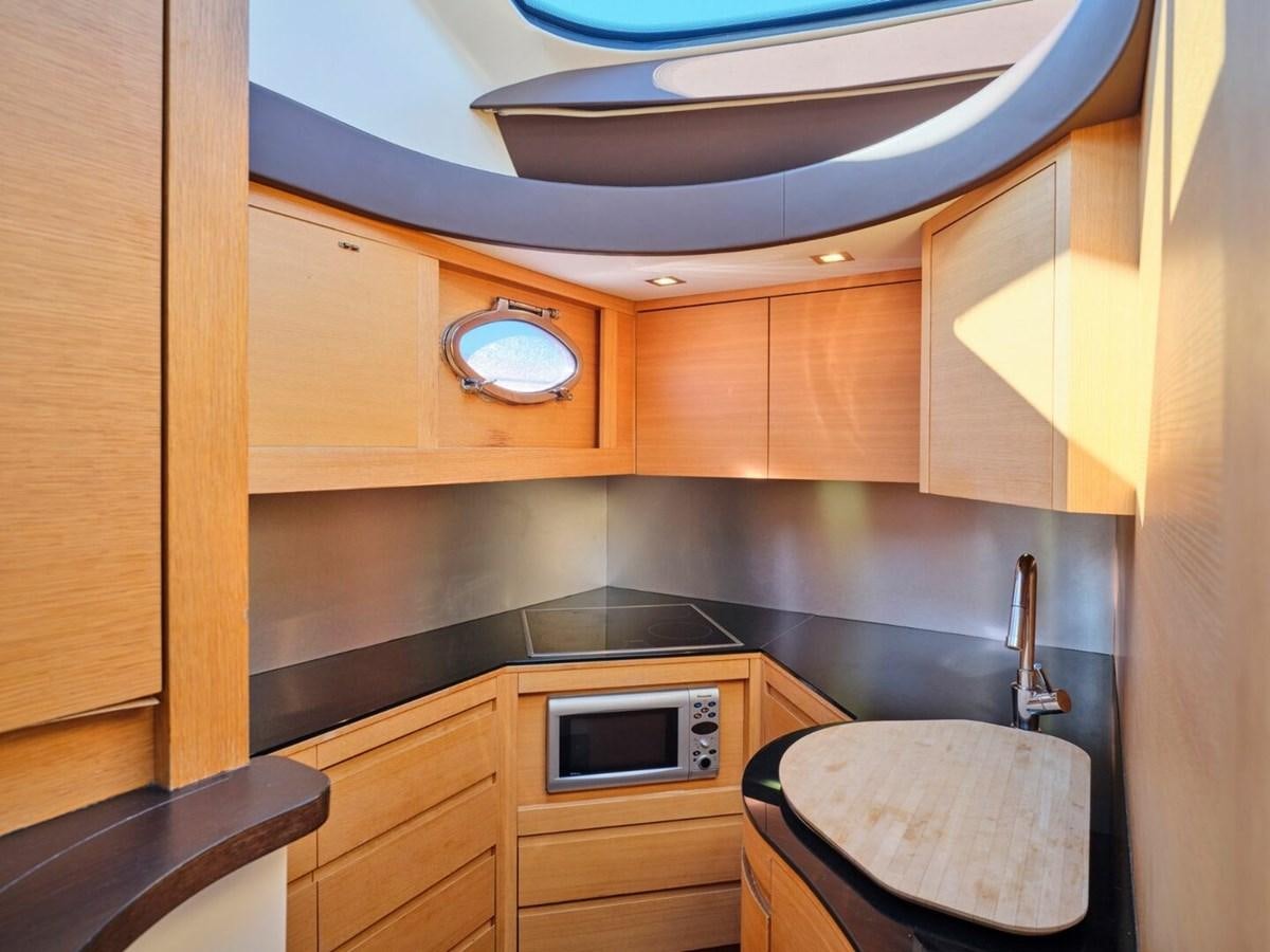 a kitchen with wooden cabinets aboard SPLENDID V Yacht for Sale