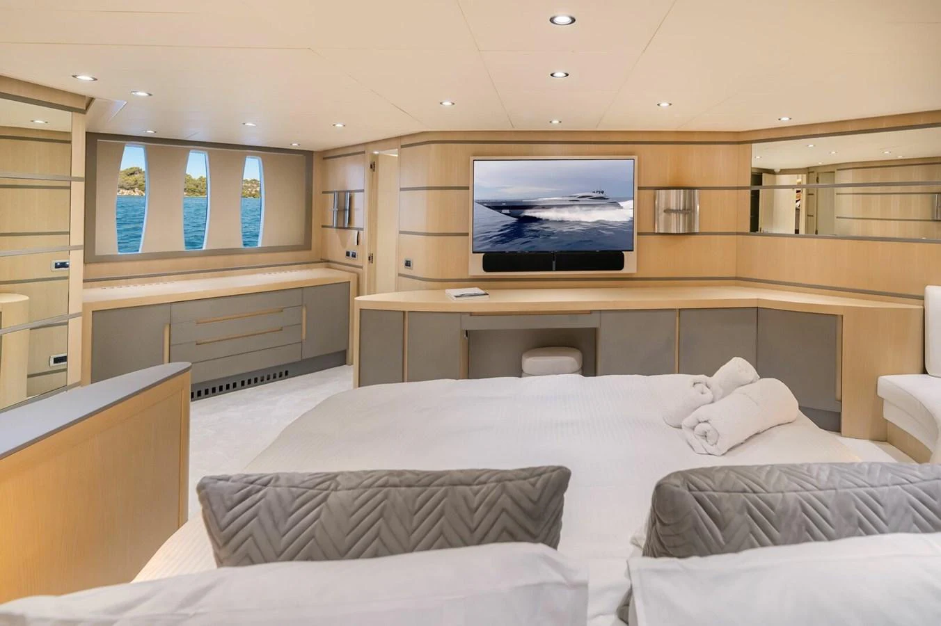 a room with a bed and a tv on the wall aboard REBOOT Yacht for Sale