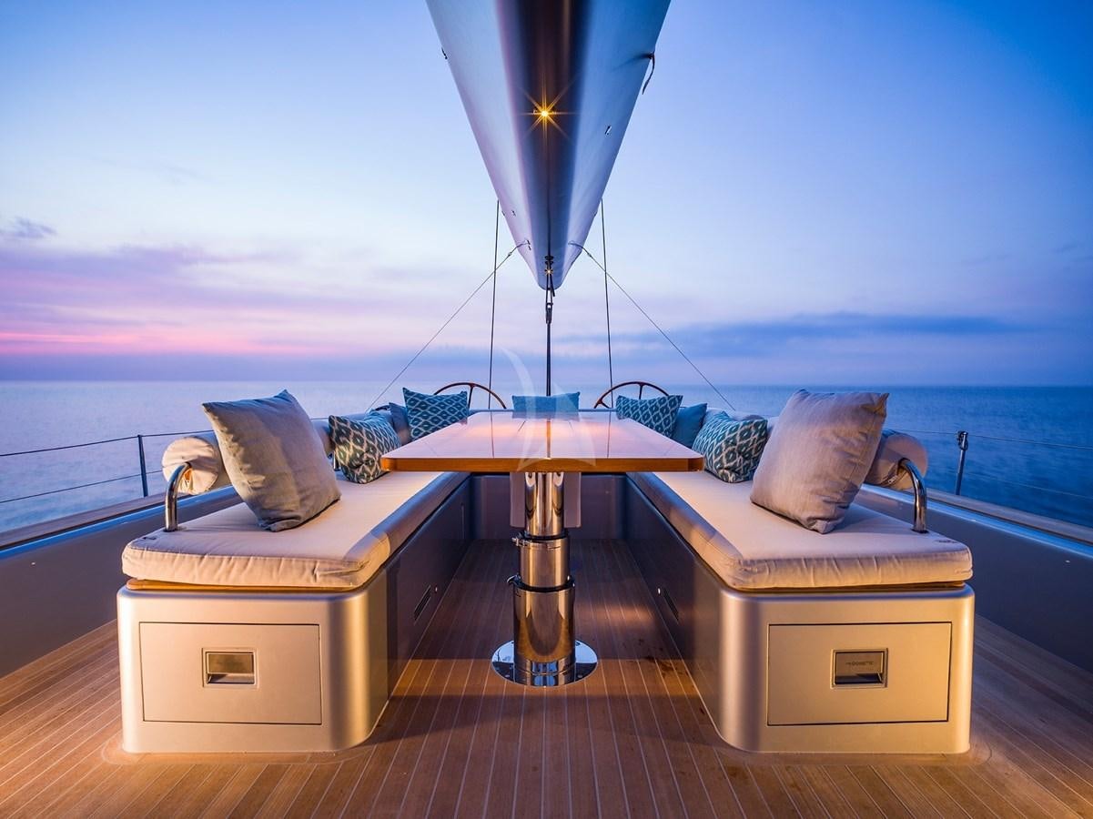 a table and chairs on a balcony aboard ONYX II Yacht for Sale