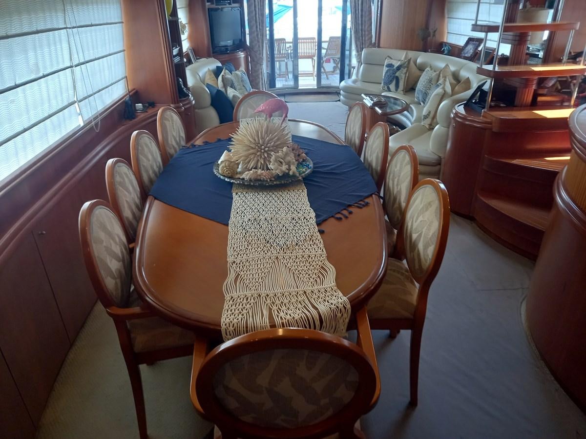 a dining room table with a blue tablecloth and a blue and white cloth on it aboard TANGO - 2003 AZIMUT 85 ULTIMATE @ ACAPULCO Yacht for Sale