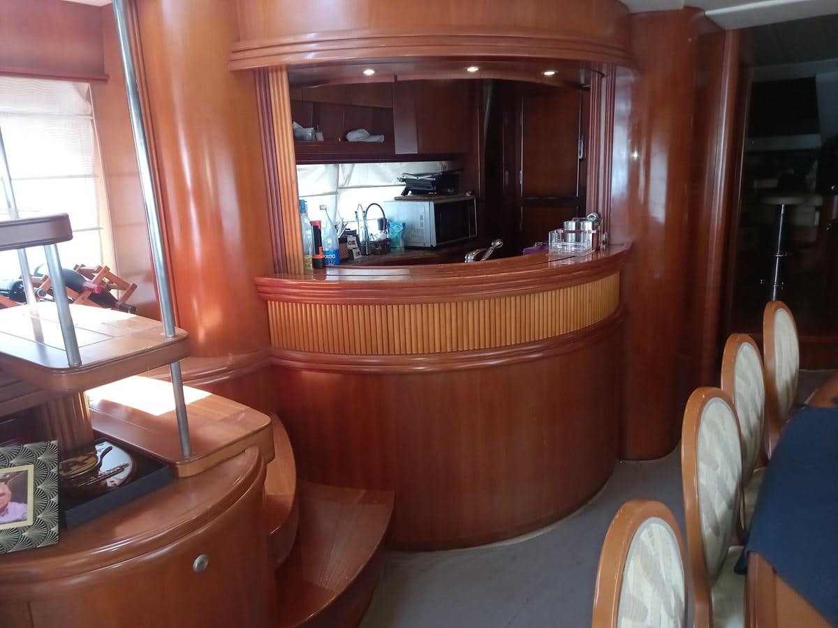 a room with a mirror and a table with chairs aboard TANGO - 2003 AZIMUT 85 ULTIMATE @ ACAPULCO Yacht for Sale
