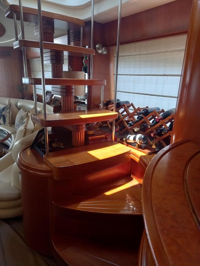a room with a shelf and chairs aboard TANGO - 2003 AZIMUT 85 ULTIMATE @ ACAPULCO Yacht for Sale
