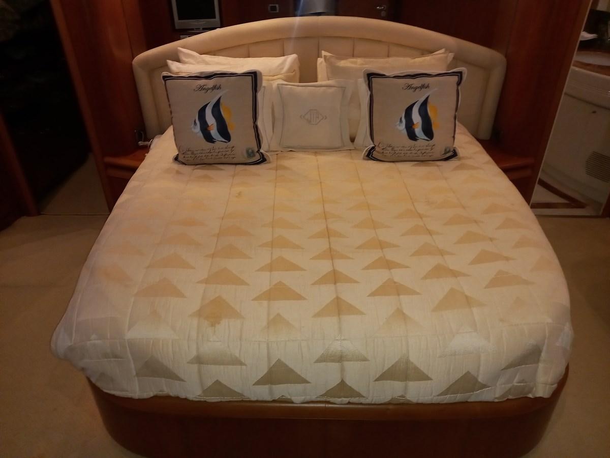 a bed with a white sheet and pillows on it aboard TANGO - 2003 AZIMUT 85 ULTIMATE @ ACAPULCO Yacht for Sale