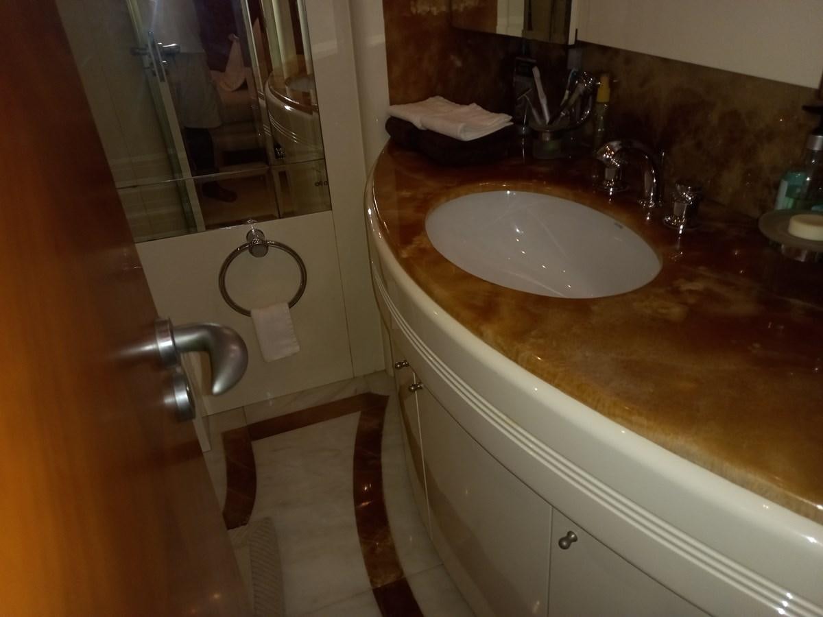a bathroom sink with a mirror aboard TANGO - 2003 AZIMUT 85 ULTIMATE @ ACAPULCO Yacht for Sale