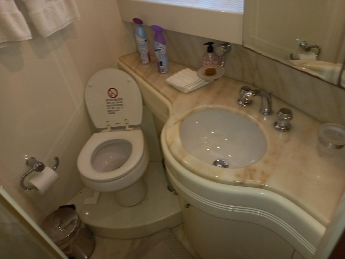 a bathroom with a toilet and sink aboard TANGO - 2003 AZIMUT 85 ULTIMATE @ ACAPULCO Yacht for Sale