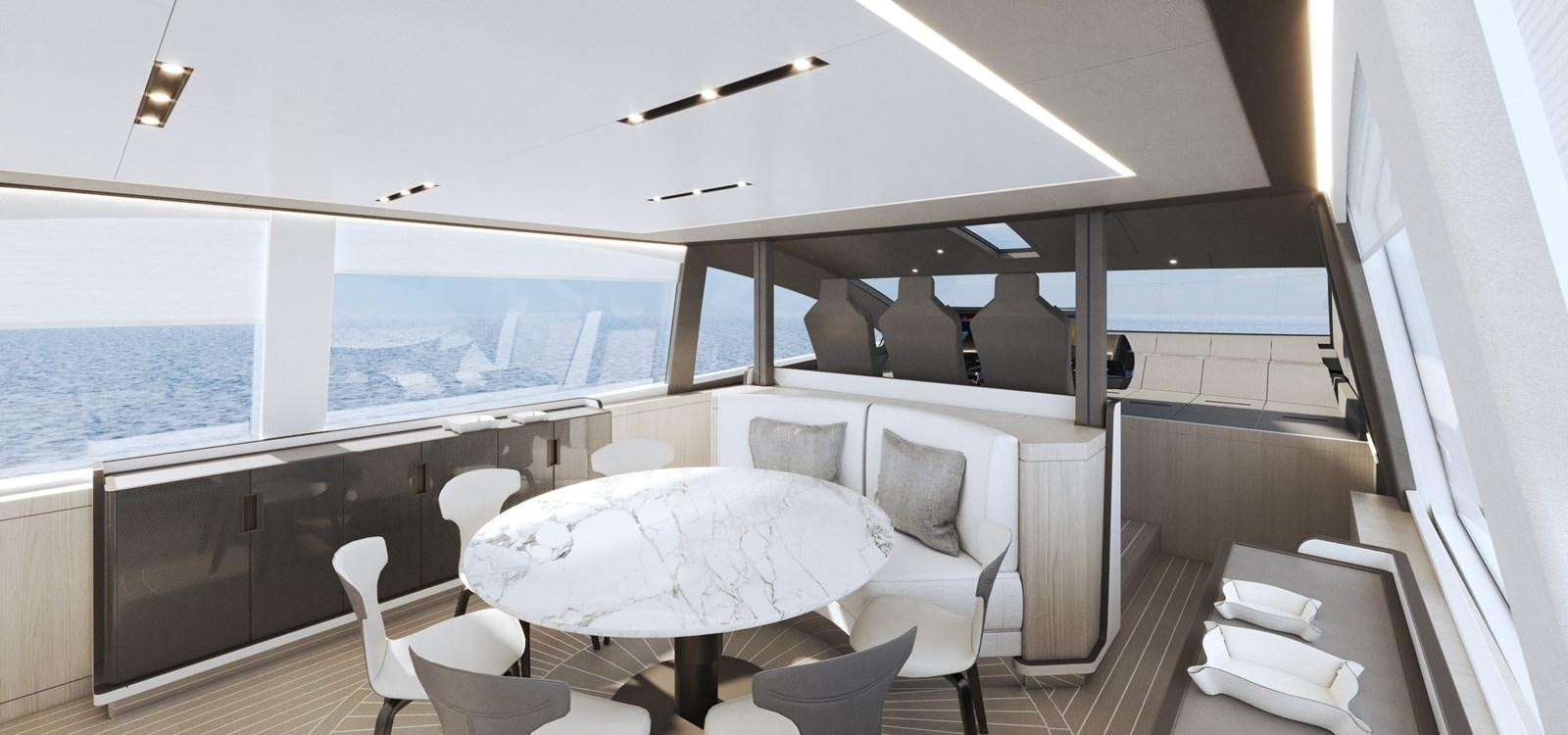 a room with a large bed and a white table with chairs aboard NEW GLADIATOR 961 SPEED Yacht for Sale
