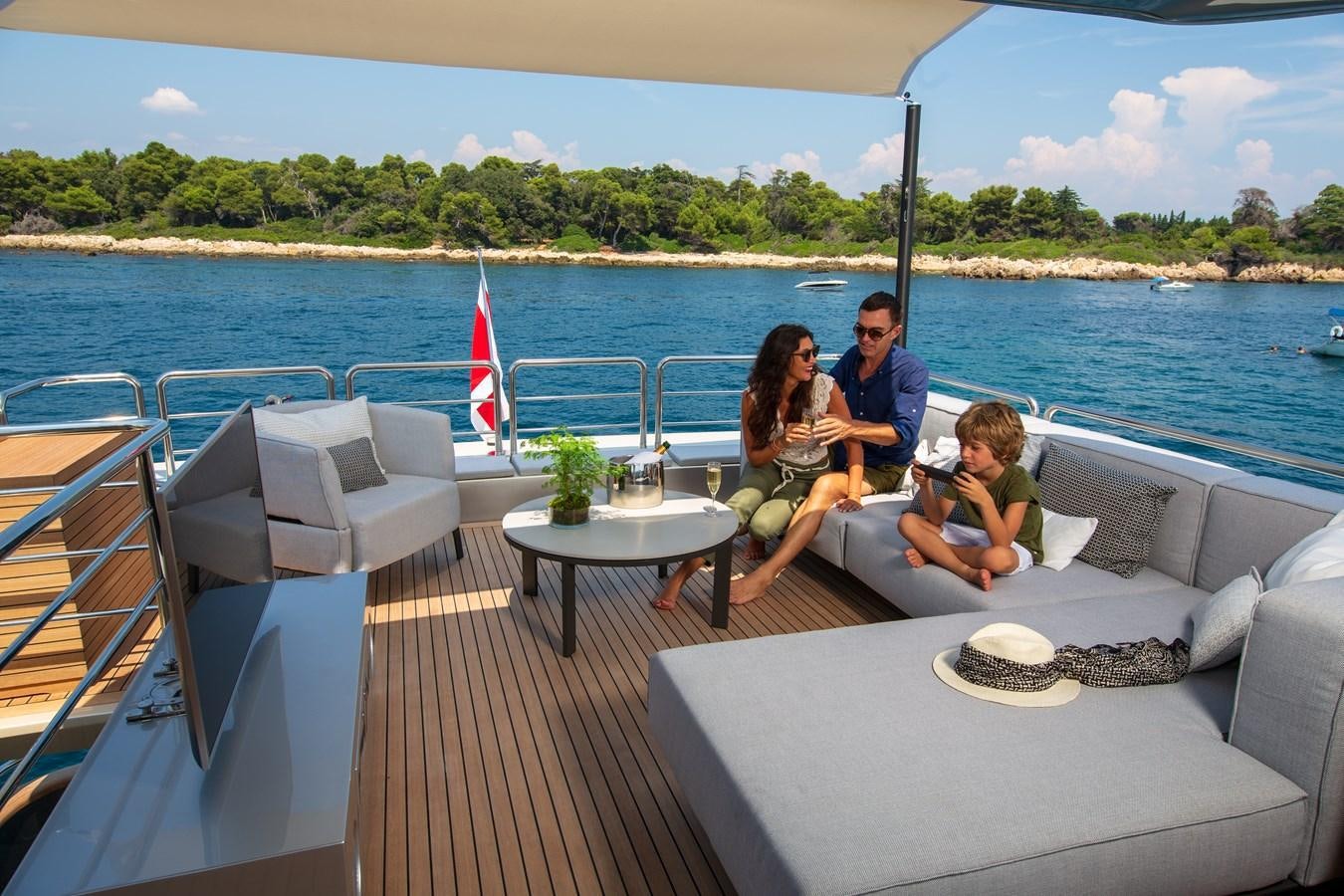 a group of people sitting on a boat on a lake aboard NEW CANADOS 888 EVO Yacht for Sale