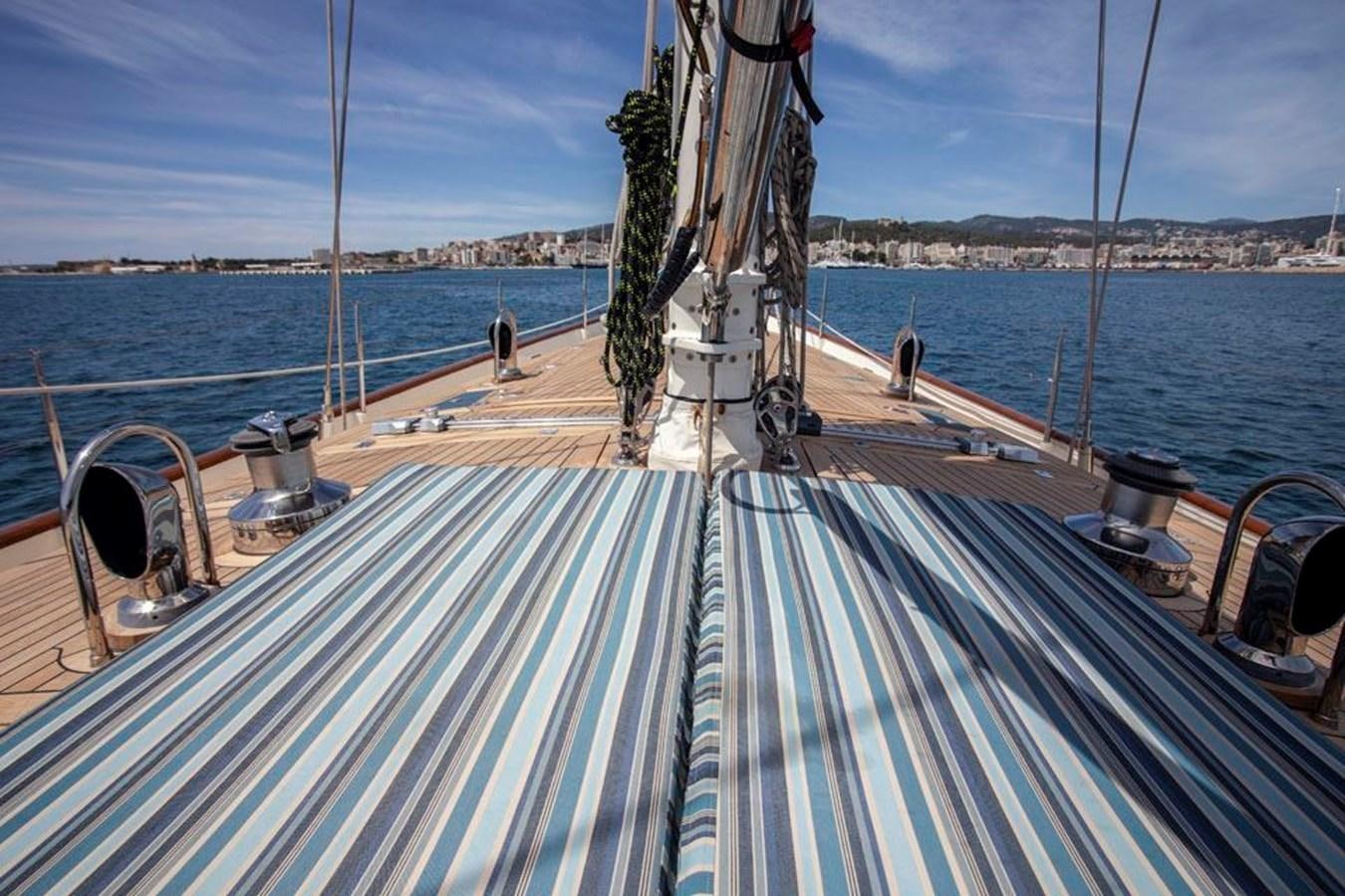 a deck with a railing and a body of water in the background aboard SWEET EMOTION Yacht for Sale