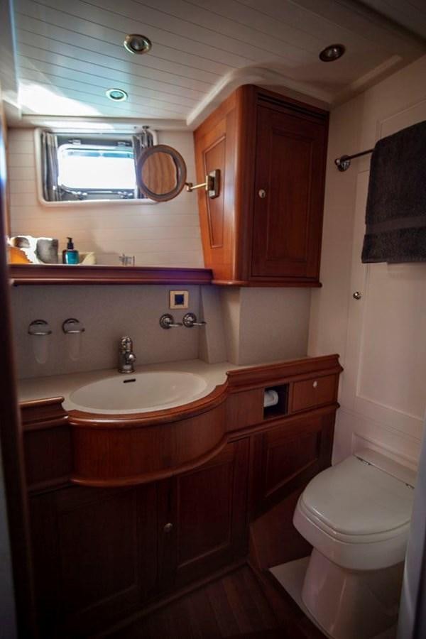 a bathroom with a toilet and a sink aboard SWEET EMOTION Yacht for Sale