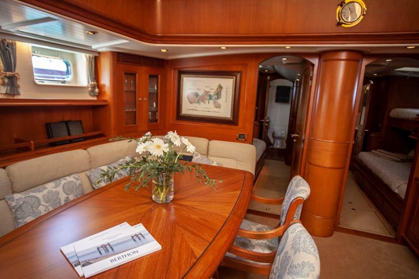a living room with a table and couches aboard SWEET EMOTION Yacht for Sale
