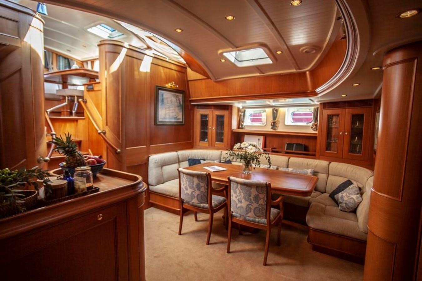 a kitchen with a table and chairs aboard SWEET EMOTION Yacht for Sale