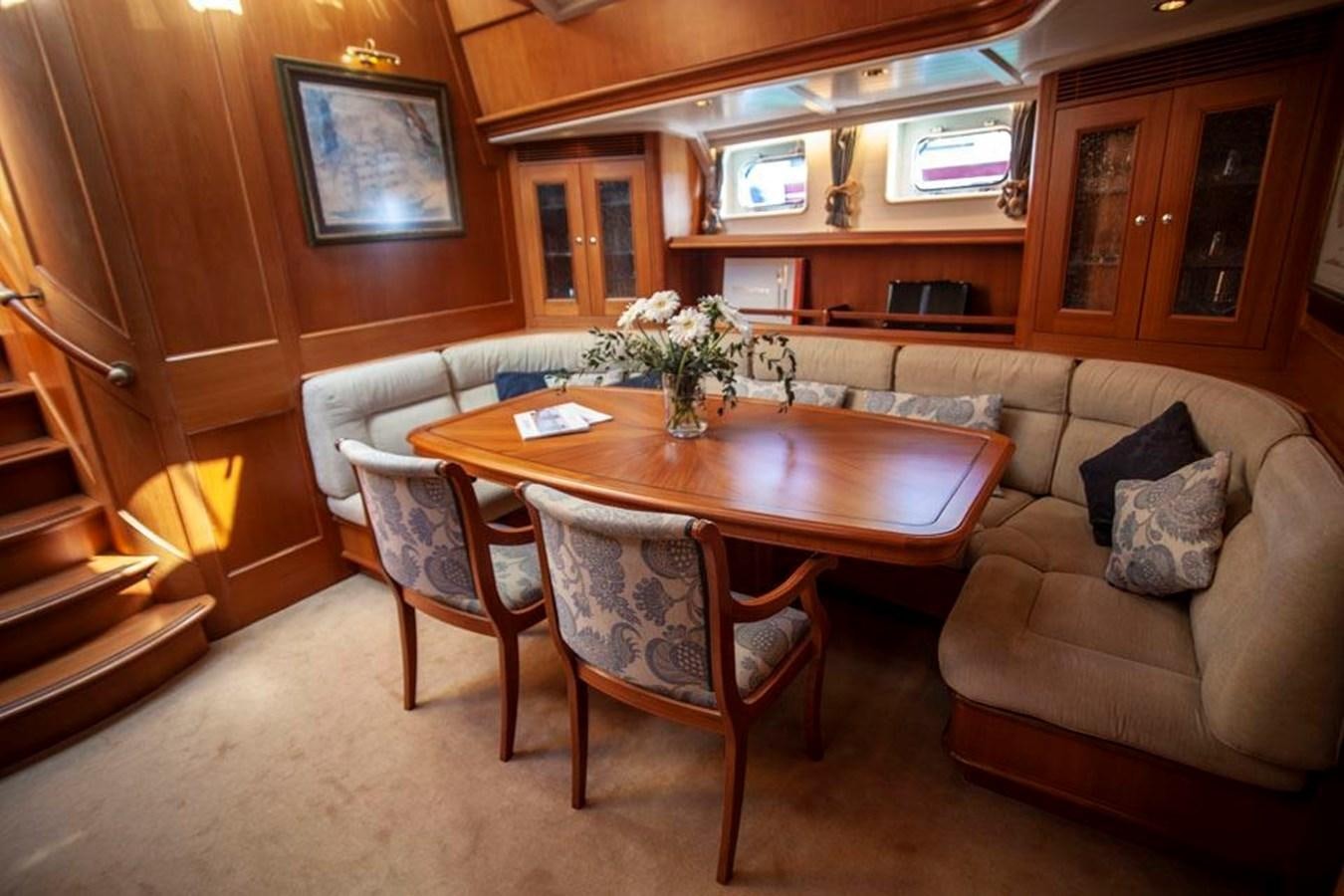 a living room with a couch and a table aboard SWEET EMOTION Yacht for Sale