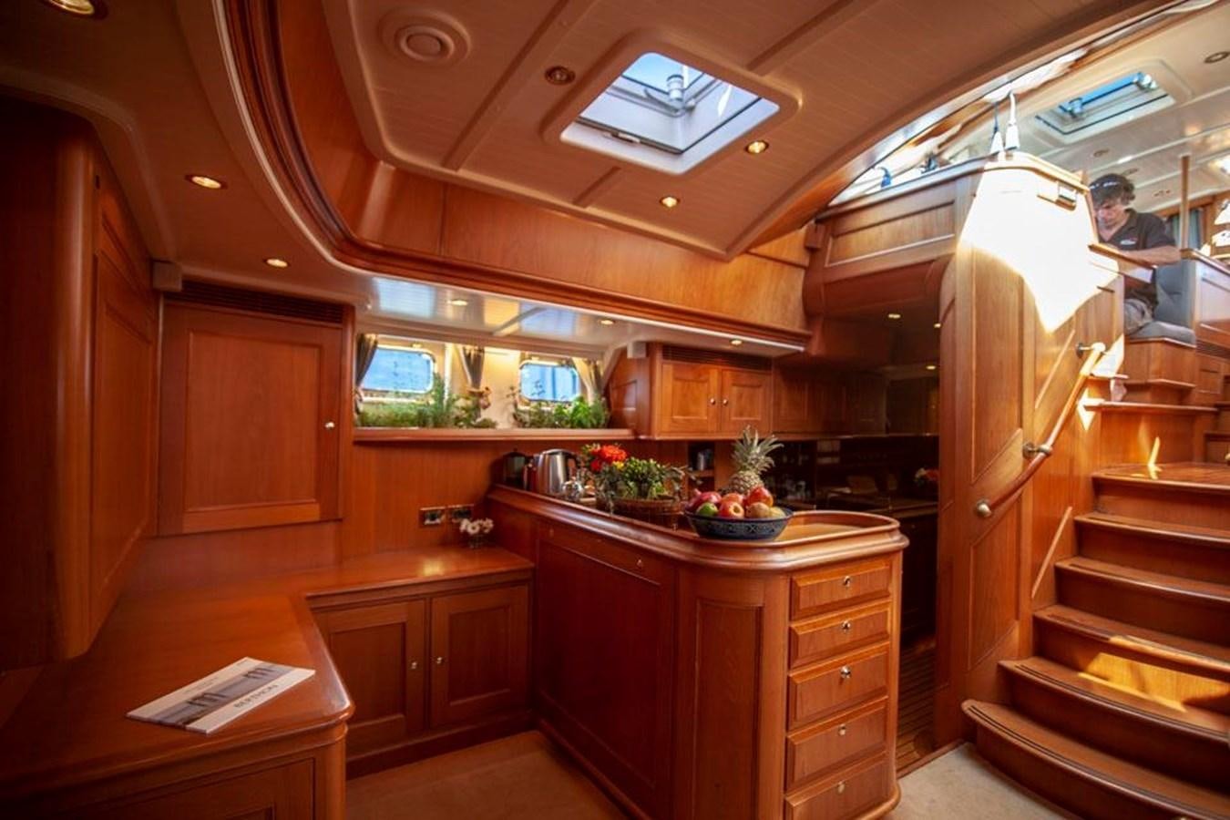 a kitchen with wooden cabinets aboard SWEET EMOTION Yacht for Sale