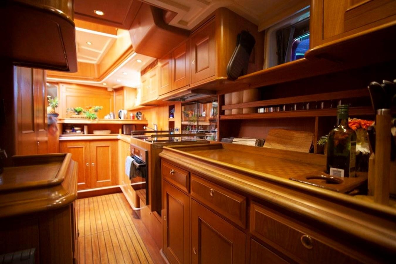 a kitchen with wooden cabinets aboard SWEET EMOTION Yacht for Sale