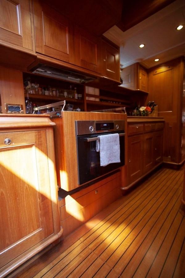 a kitchen with wooden cabinets aboard SWEET EMOTION Yacht for Sale